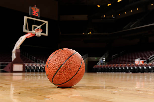 Basketball on the floor of a indoor court.