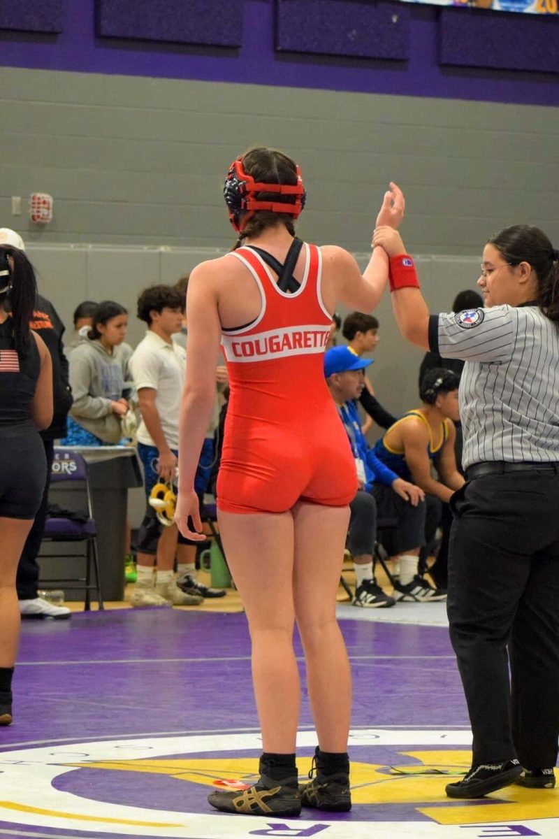 Wrestler Makenzie Loper Stands for victory after one of her matches.